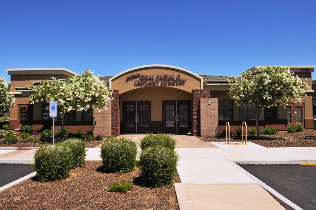 Exterior of dental office building with brick facade, trees, and entrance