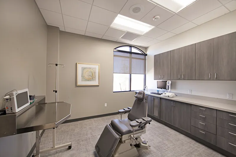 Dental examination room with chair, window, cabinets, and equipment