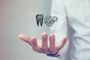 Person in white shirt extending hand with tooth icon and money stacks floating above palm